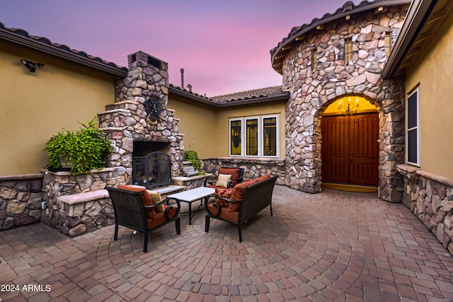 view of patio with an outdoor living space with a fireplace