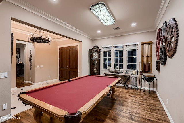 game room featuring visible vents, baseboards, wood finished floors, and crown molding