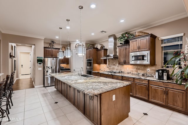 kitchen featuring visible vents, ornamental molding, tasteful backsplash, stainless steel appliances, and wall chimney range hood