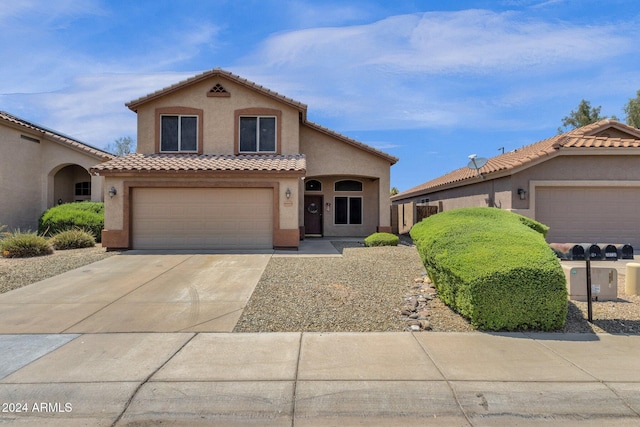 mediterranean / spanish-style home with a garage