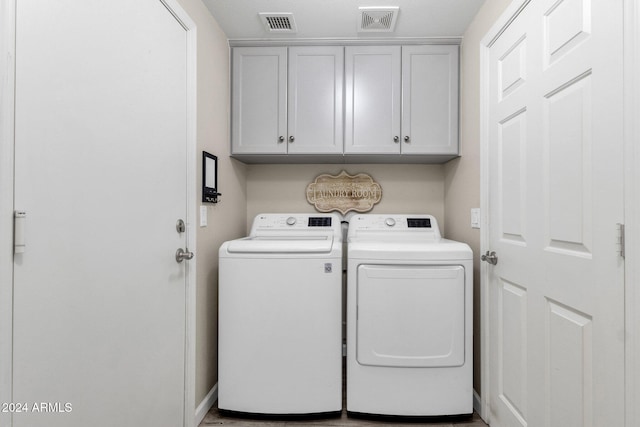 laundry room with cabinets and separate washer and dryer