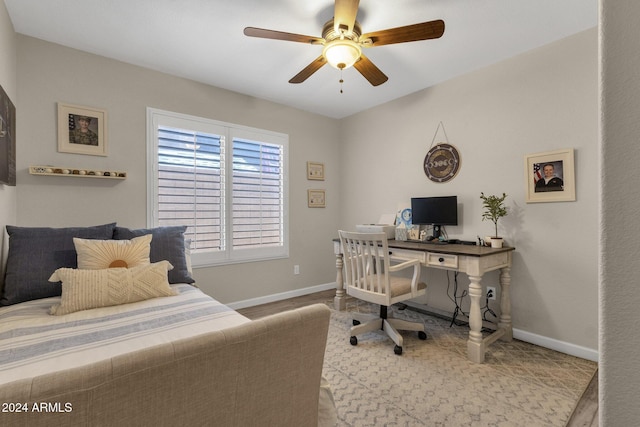 bedroom with light hardwood / wood-style floors and ceiling fan