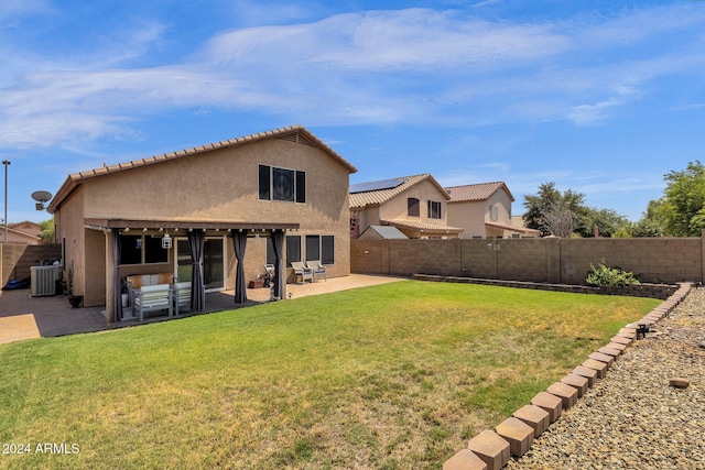 rear view of property with a patio, central AC unit, and a lawn