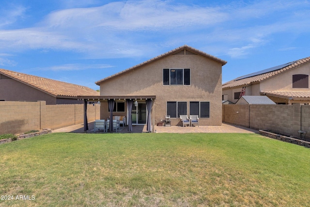 back of property featuring a lawn and a patio