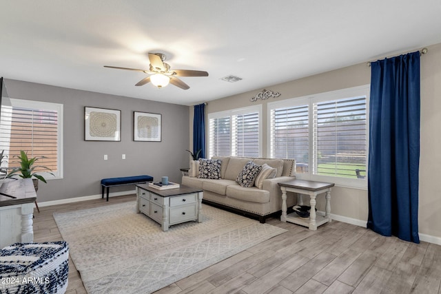 living room featuring ceiling fan and light hardwood / wood-style flooring