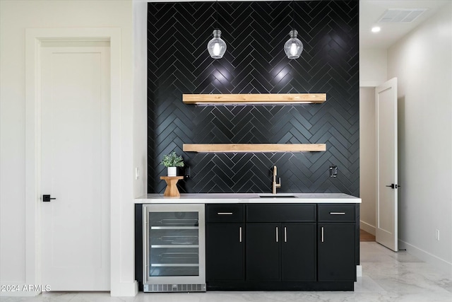 bar with beverage cooler, a sink, visible vents, baseboards, and marble finish floor