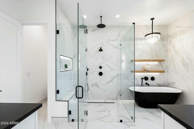 bathroom with marble finish floor, a marble finish shower, a freestanding bath, and vanity