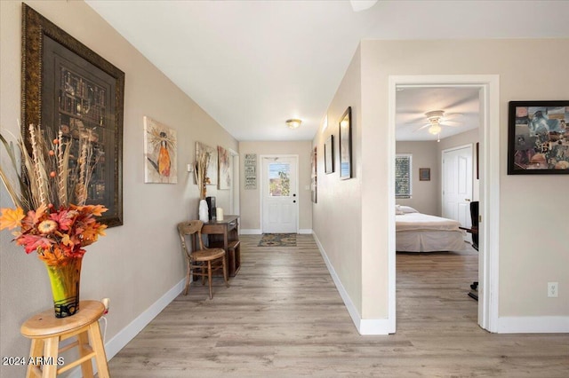 entryway featuring baseboards and light wood-type flooring