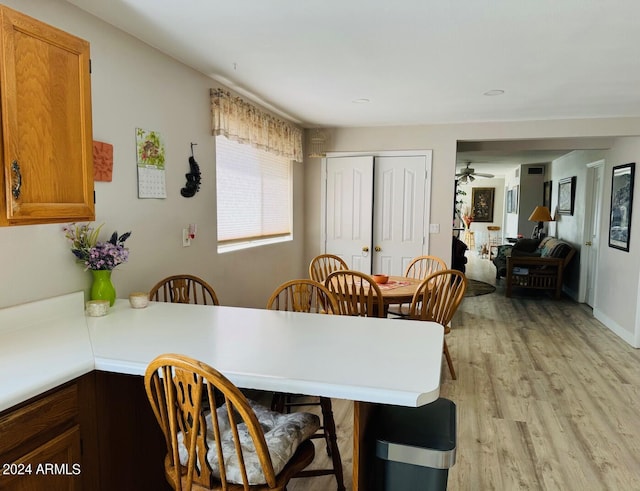 dining room featuring light wood-type flooring and a ceiling fan