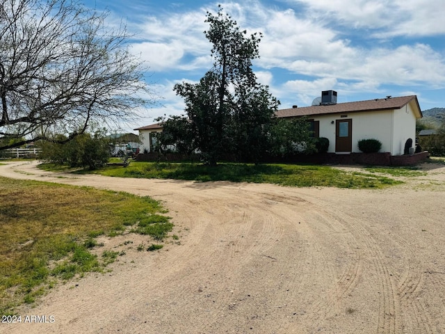 exterior space featuring stucco siding and driveway