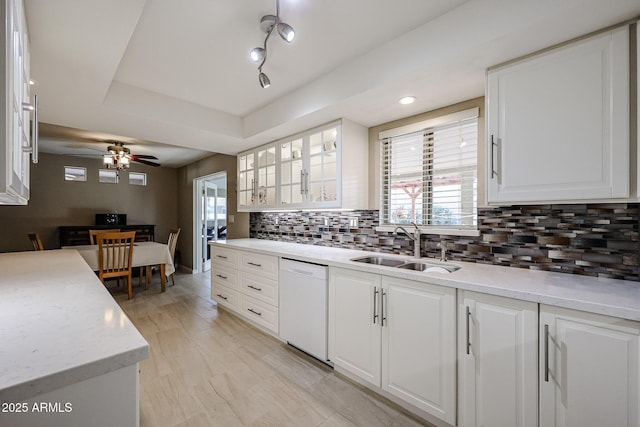 kitchen featuring dishwasher, white cabinets, and sink