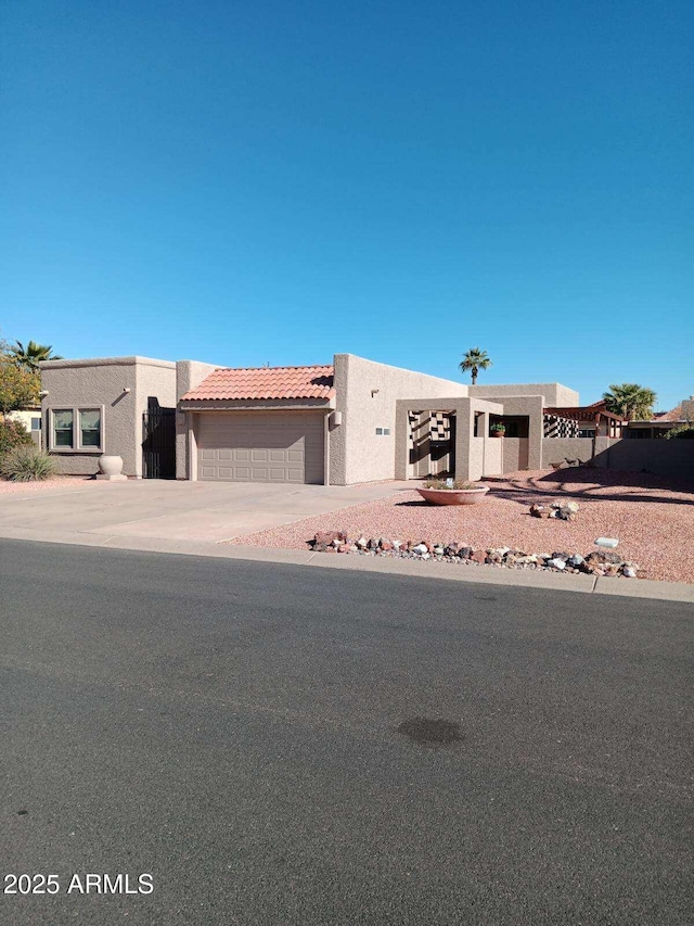 pueblo-style house with a garage