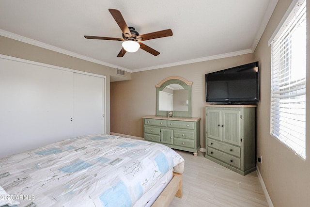 bedroom with ceiling fan, a closet, and ornamental molding