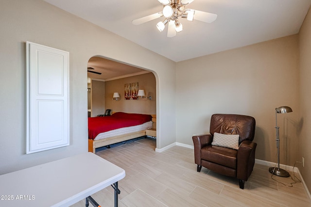 bedroom with ceiling fan and crown molding