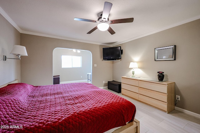 bedroom featuring ceiling fan, crown molding, and wood-type flooring