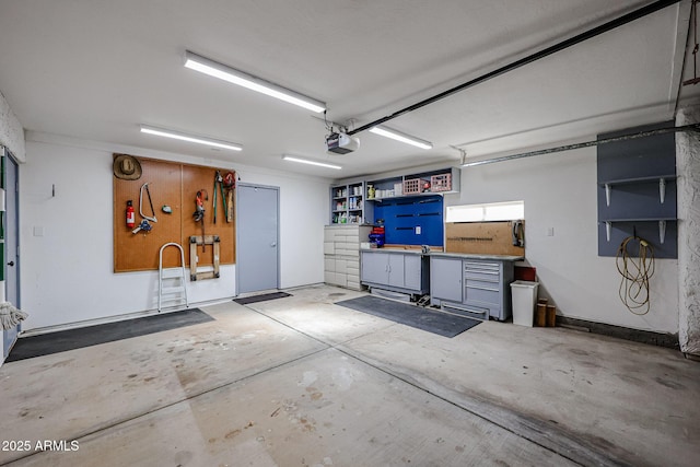 garage with a garage door opener and a workshop area