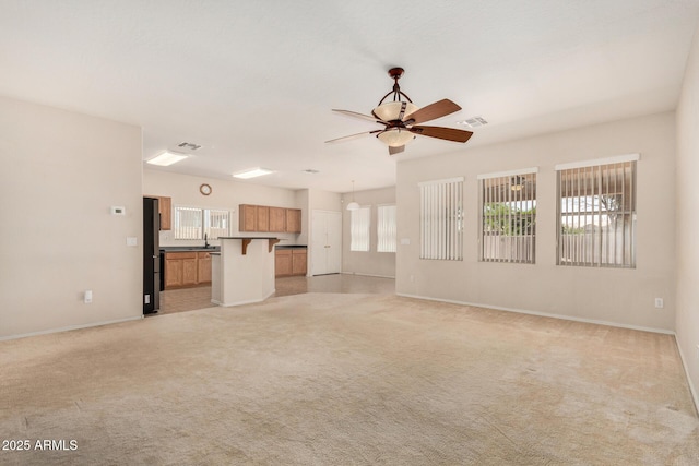 11511 E Renata Ave, Mesa, AZ 85212 - unfurnished living room featuring ceiling fan, light colored carpet, baseboards, and a sink