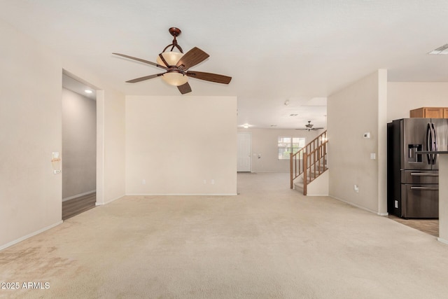 11511 E Renata Ave, Mesa, AZ 85212 - unfurnished living room featuring ceiling fan, light carpet, baseboards, and stairs