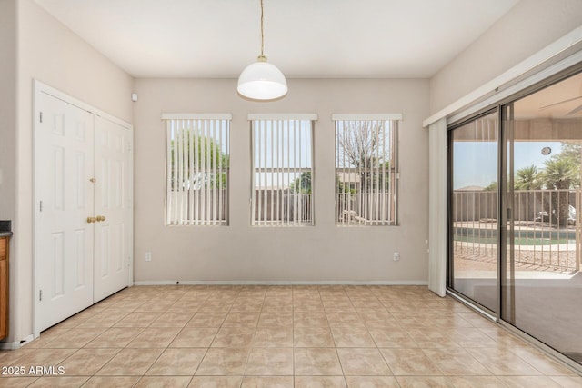 11511 E Renata Ave, Mesa, AZ 85212 - unfurnished dining area with light tile patterned floors and baseboards