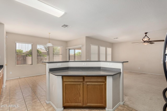 11511 E Renata Ave, Mesa, AZ 85212 - kitchen with dark countertops, plenty of natural light, ceiling fan, and baseboards