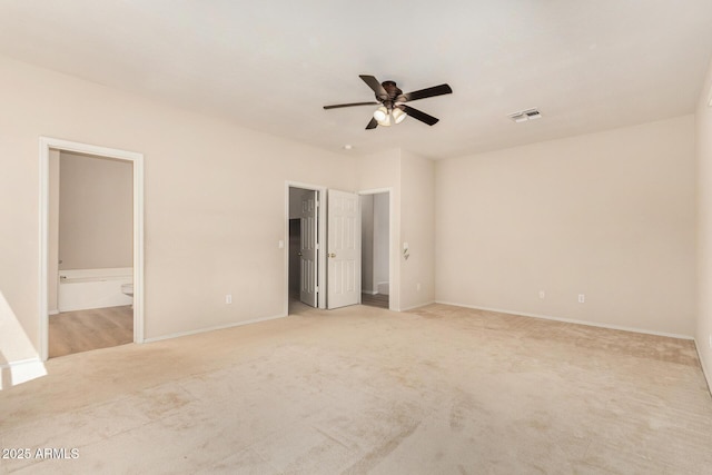 11511 E Renata Ave, Mesa, AZ 85212 - unfurnished bedroom with light carpet, ensuite bath, baseboards, a spacious closet, and a ceiling fan