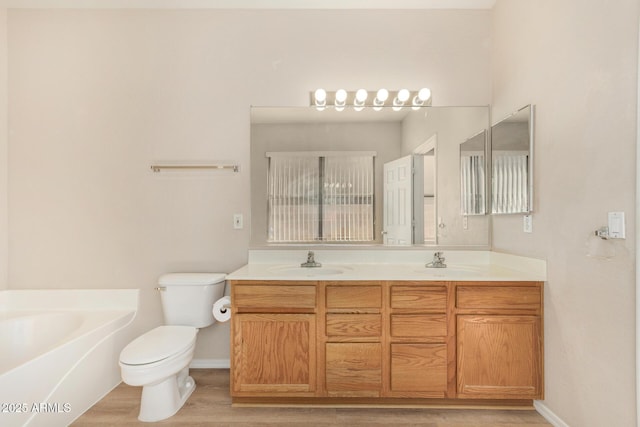 11511 E Renata Ave, Mesa, AZ 85212 - bathroom with toilet, wood finished floors, double vanity, a garden tub, and baseboards