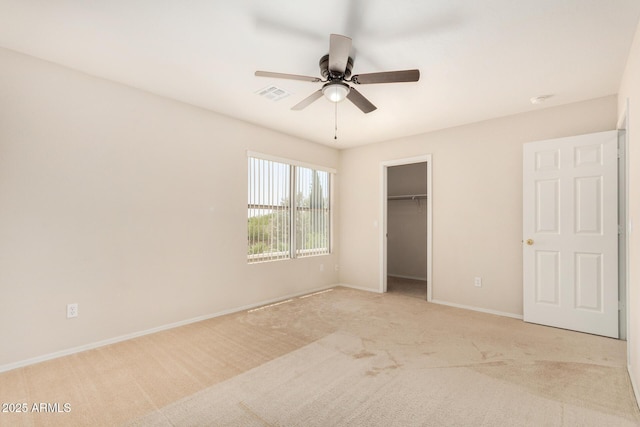 11511 E Renata Ave, Mesa, AZ 85212 - unfurnished bedroom with light carpet, baseboards, a ceiling fan, a closet, and a walk in closet