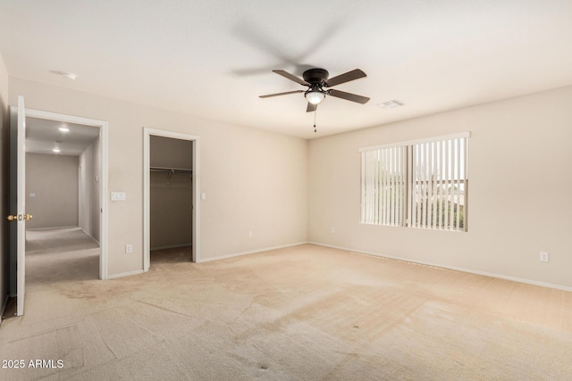 11511 E Renata Ave, Mesa, AZ 85212 - unfurnished bedroom with light colored carpet, a walk in closet, baseboards, a ceiling fan, and a closet