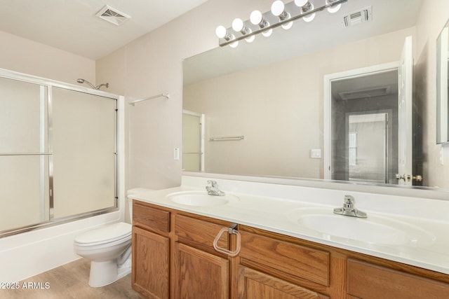 11511 E Renata Ave, Mesa, AZ 85212 - full bath with toilet, shower / bath combination with glass door, wood finished floors, and double vanity