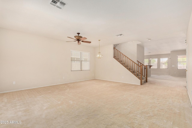 11511 E Renata Ave, Mesa, AZ 85212 - unfurnished living room with stairway, a ceiling fan, a chandelier, light colored carpet, and baseboards