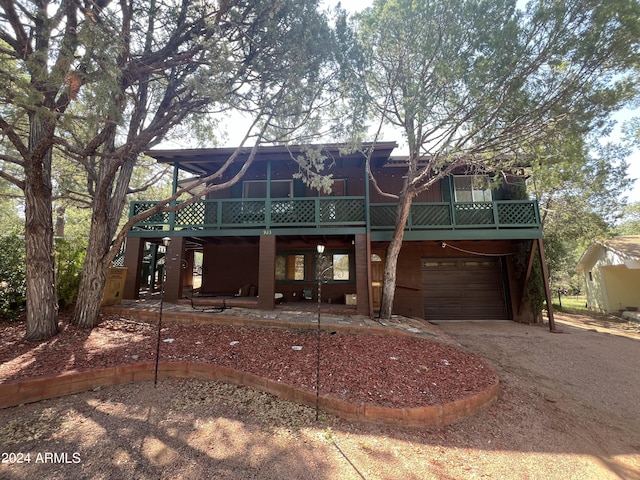 view of front of house featuring dirt driveway and a garage