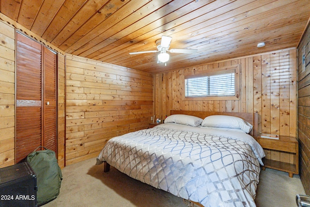 bedroom with wooden walls, wooden ceiling, ceiling fan, and carpet floors