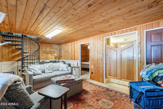 living room featuring stairs, wood walls, and wooden ceiling