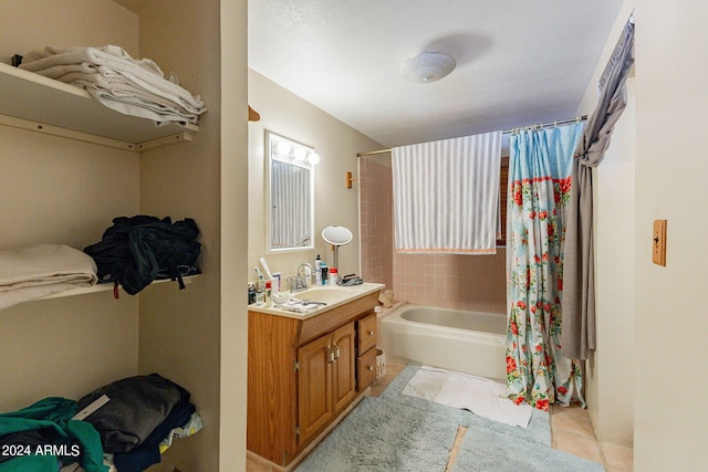 full bath with shower / bath combo, vanity, and tile patterned floors