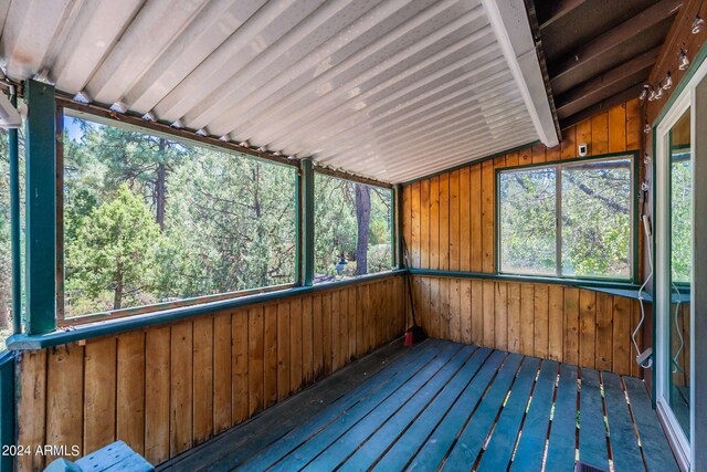 wooden deck with a storage shed