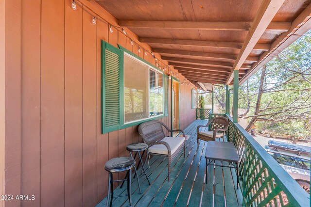 view of patio with ceiling fan and a storage unit