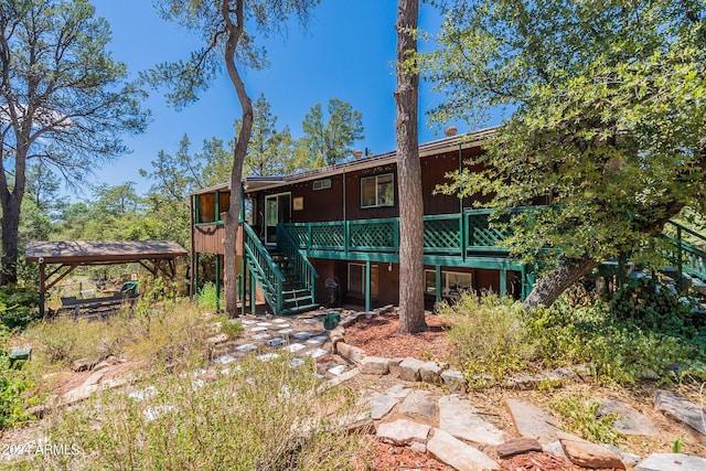 back of house with a deck and stairway