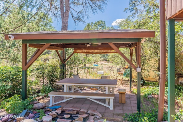 view of patio featuring fence and a gazebo