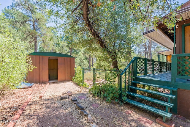 view of yard with a storage shed and a wooden deck