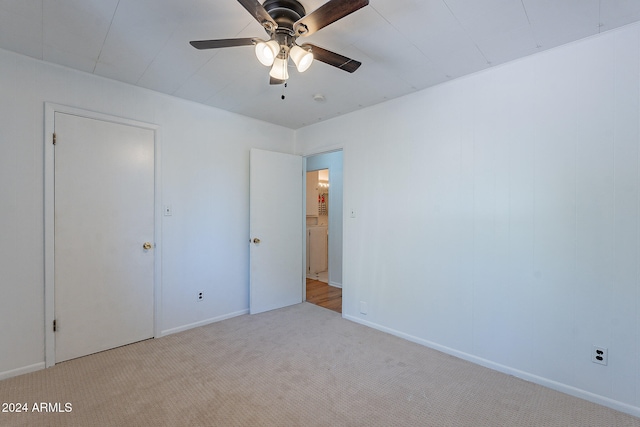 unfurnished bedroom featuring light colored carpet and ceiling fan