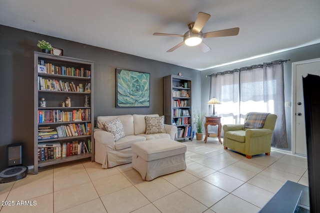 living area featuring light tile patterned floors and ceiling fan