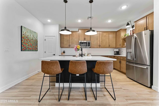 27510 N 30th Ln, Phoenix, AZ 85083 - kitchen featuring stainless steel appliances, light countertops, light wood-type flooring, and recessed lighting