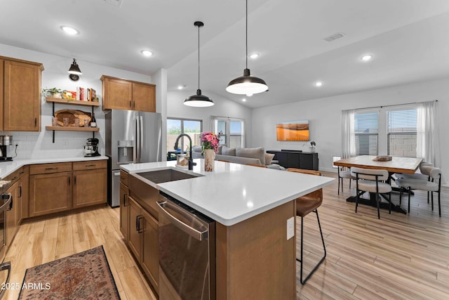 27510 N 30th Ln, Phoenix, AZ 85083 - kitchen featuring stainless steel appliances, a sink, lofted ceiling, open shelves, and brown cabinets