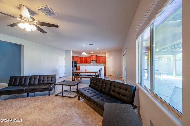 tiled living room with ceiling fan