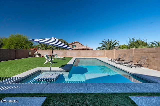 view of pool featuring a lawn