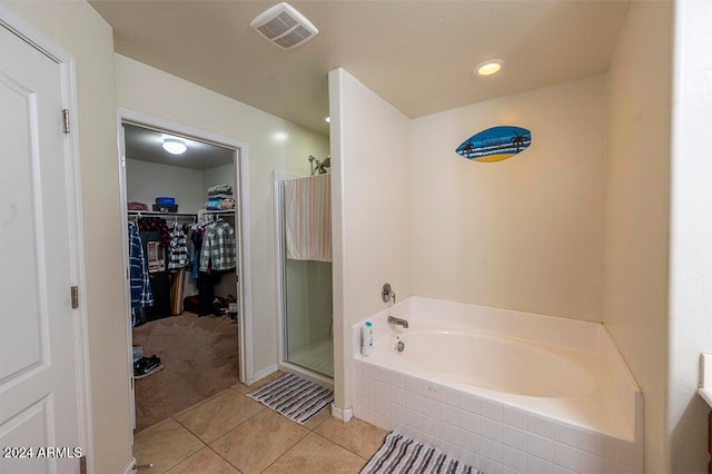 bathroom featuring tile patterned flooring and independent shower and bath