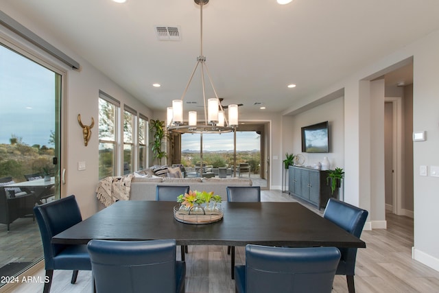 dining room with a chandelier and light hardwood / wood-style flooring