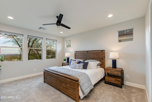 bedroom featuring ceiling fan and light colored carpet