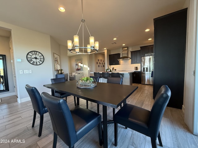 dining area with a chandelier and light hardwood / wood-style floors