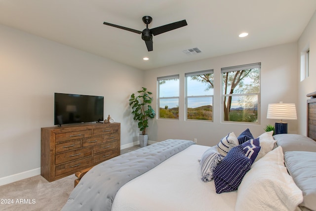 bedroom with ceiling fan and light colored carpet